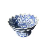 AN UNUSUAL CHINESE BLUE AND WHITE DOUBLE LOTUS FORM STEM BOWL Decorated with three dragons chasing