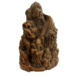 AN ORIENTAL CARVED GROUP, FIGURES ON A MOUNTAIN. (h 18cm)