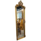 A ROCOCO DESIGN GILT PIER MIRROR With central cartouche and scrolling foliage decoration. (177cm x