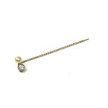 A LATE VICTORIAN YELLOW METAL, DIAMOND AND PEARL STICK PIN. (approx diamond weight 0.60ct, length