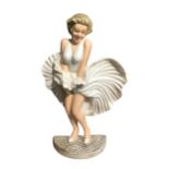 A CAST IRON DOORSTOP IN THE FORM OF MARILYN MONROE HAVING FUN. (h 33.5cm x w 14.5cm)