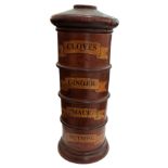 A FOUR TIER TURNED WOOD SPICE TOWER CLOVES, GINGER, MACE, NUTMEG. (h 29cm x diameter 8cm)