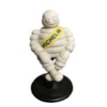 A CAST IRON MICHELIN MAN DOORSTOP. (h 28cm x diameter 15.5cm)