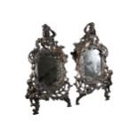 A VICTORIAN PAIR OF ART NOUVEAU CAST METAL MIRRORS Decorated with a cherub and female figure amongst