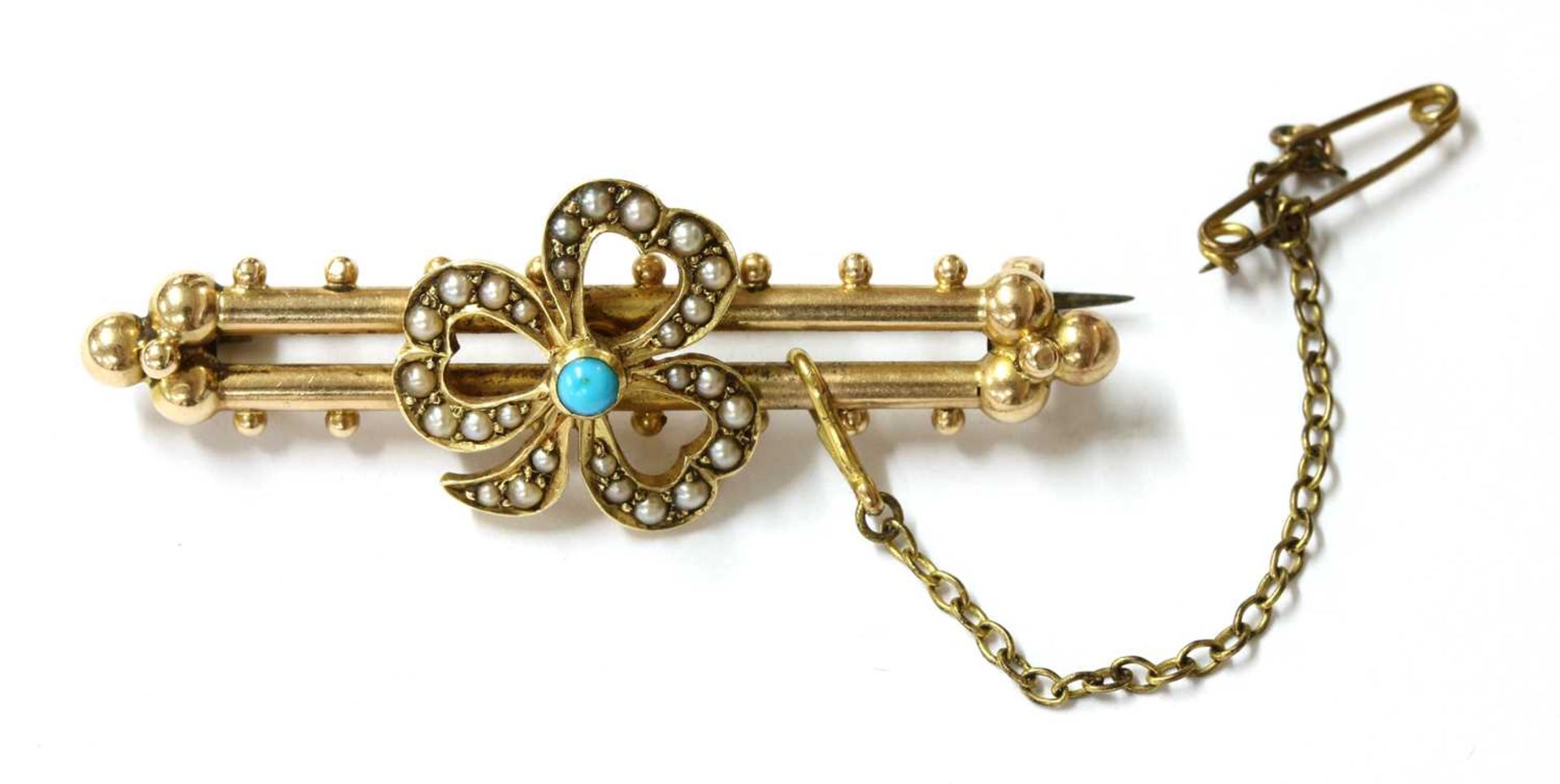 A gold turquoise and split pearl shamrock brooch,