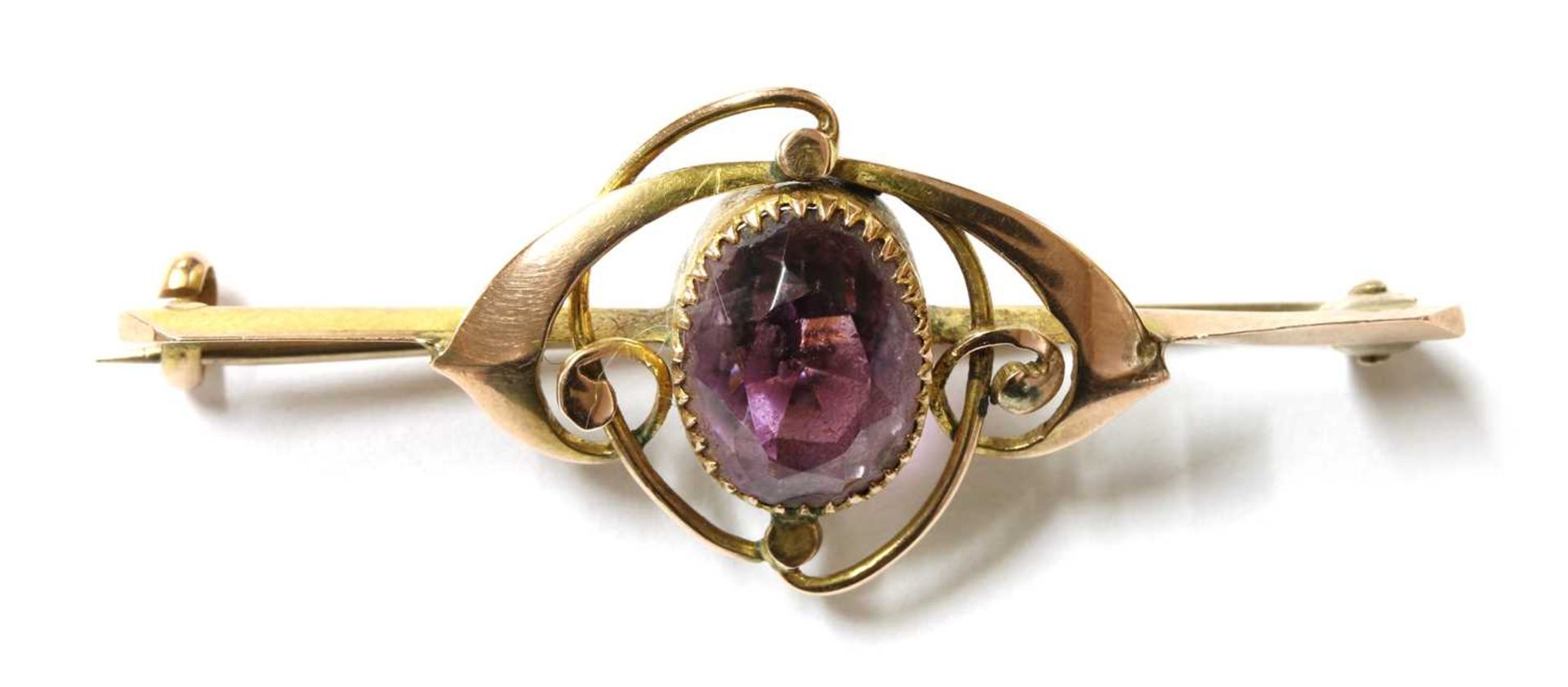 A gold single stone amethyst brooch,