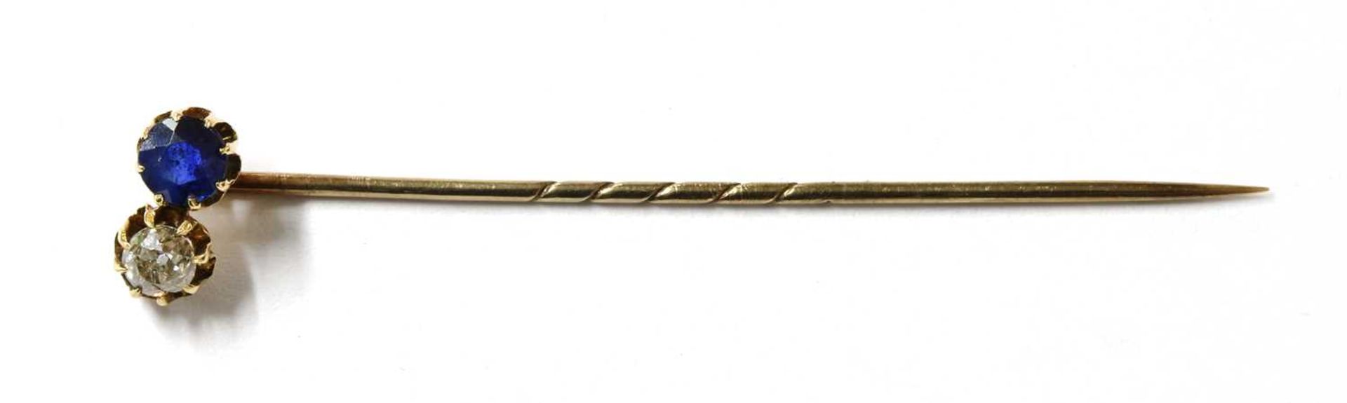 A gold sapphire and diamond stick pin,