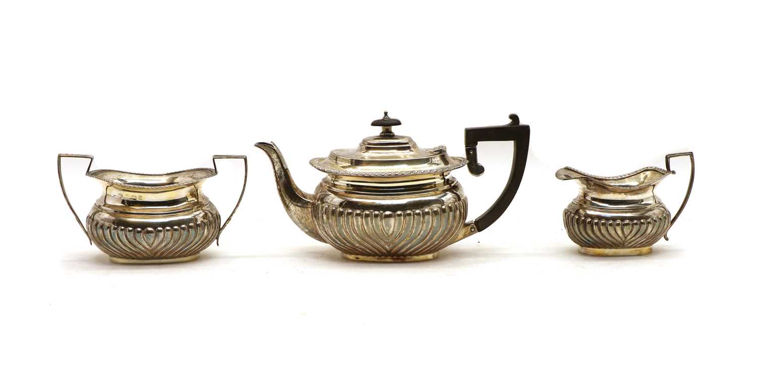 A composed three piece silver tea service,