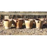 A set of four small terracotta pots,