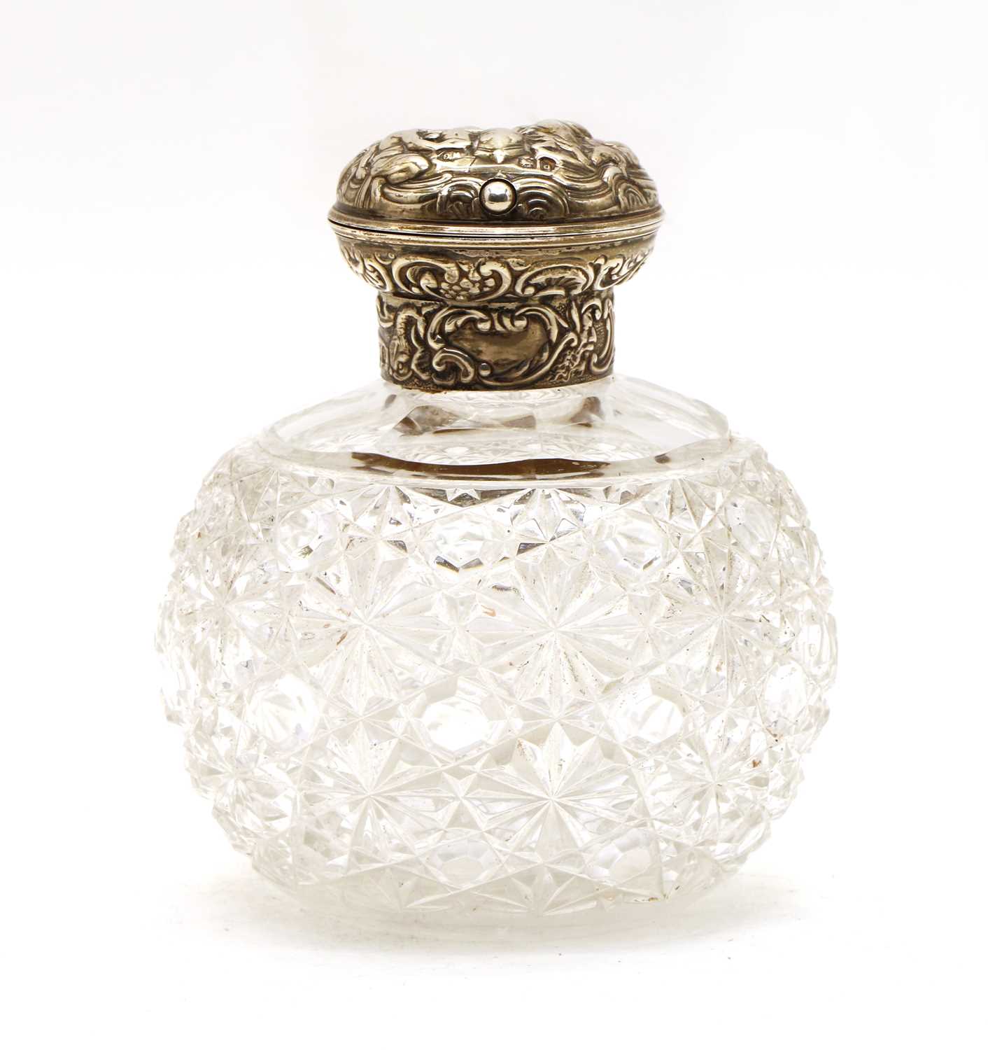 A William Commyns silver topped cut glass perfume bottle,