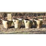 A set of four small terracotta pots,