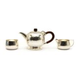 A mid-century faintly planished three piece tea service,