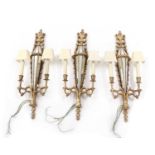 A set of three gilt-composite and glass wall lights,