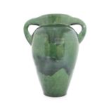 A green glazed twin handled vase,