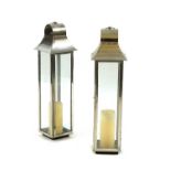 A pair of tall chromed lanterns,