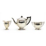 A George III style three piece silver tea set,