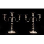 A pair of twin-branch cast silver candlesticks,