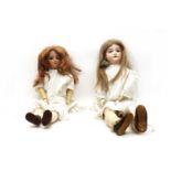 A pair of large bisque head dolls,