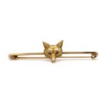 A gold fox head bar brooch,