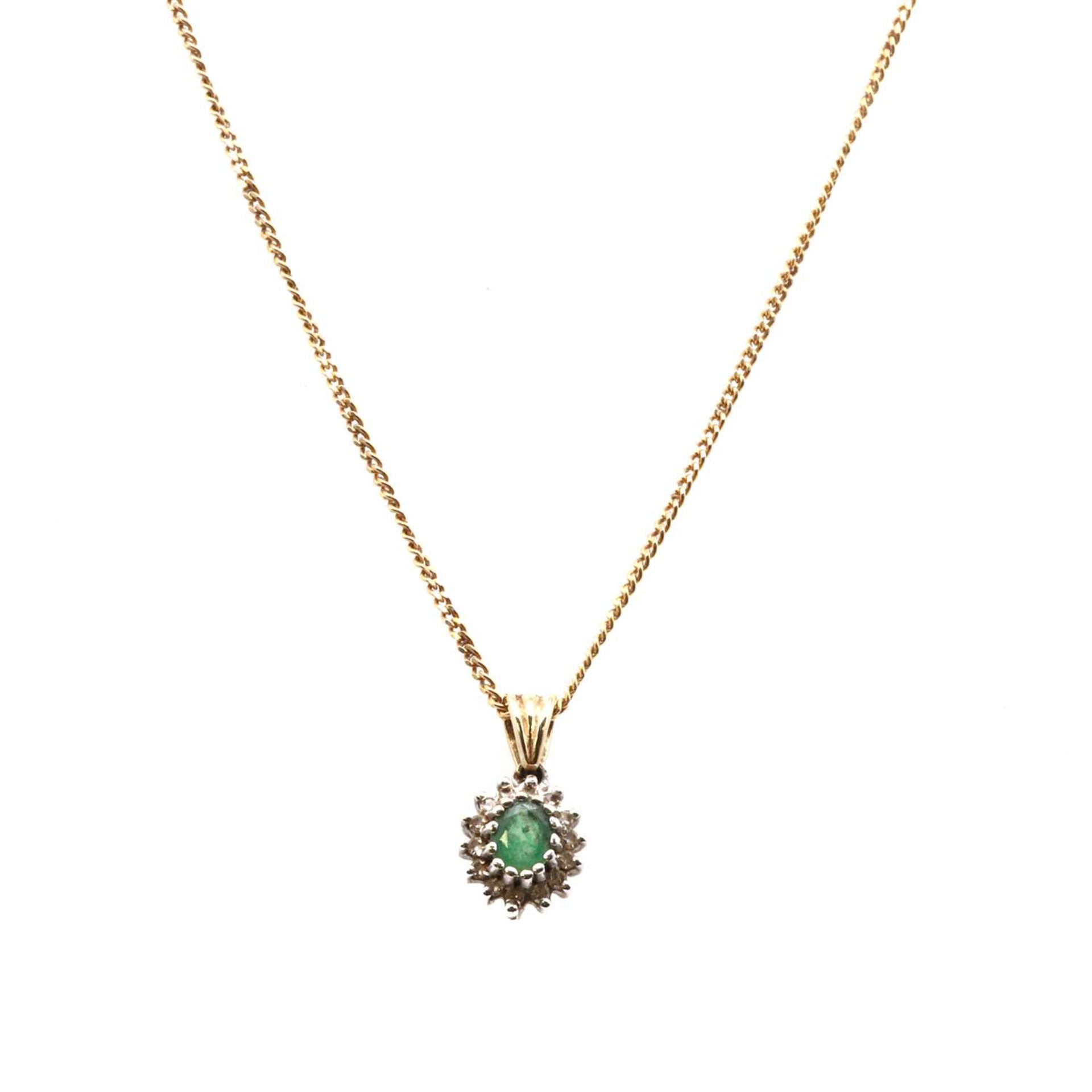 A gold emerald and diamond cluster pendant,