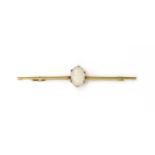 A gold single stone opal bar brooch,