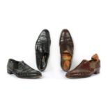 A pair of John Lobb black crocodile leather slip-on shoes,