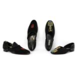 A pair of black suede shoes,