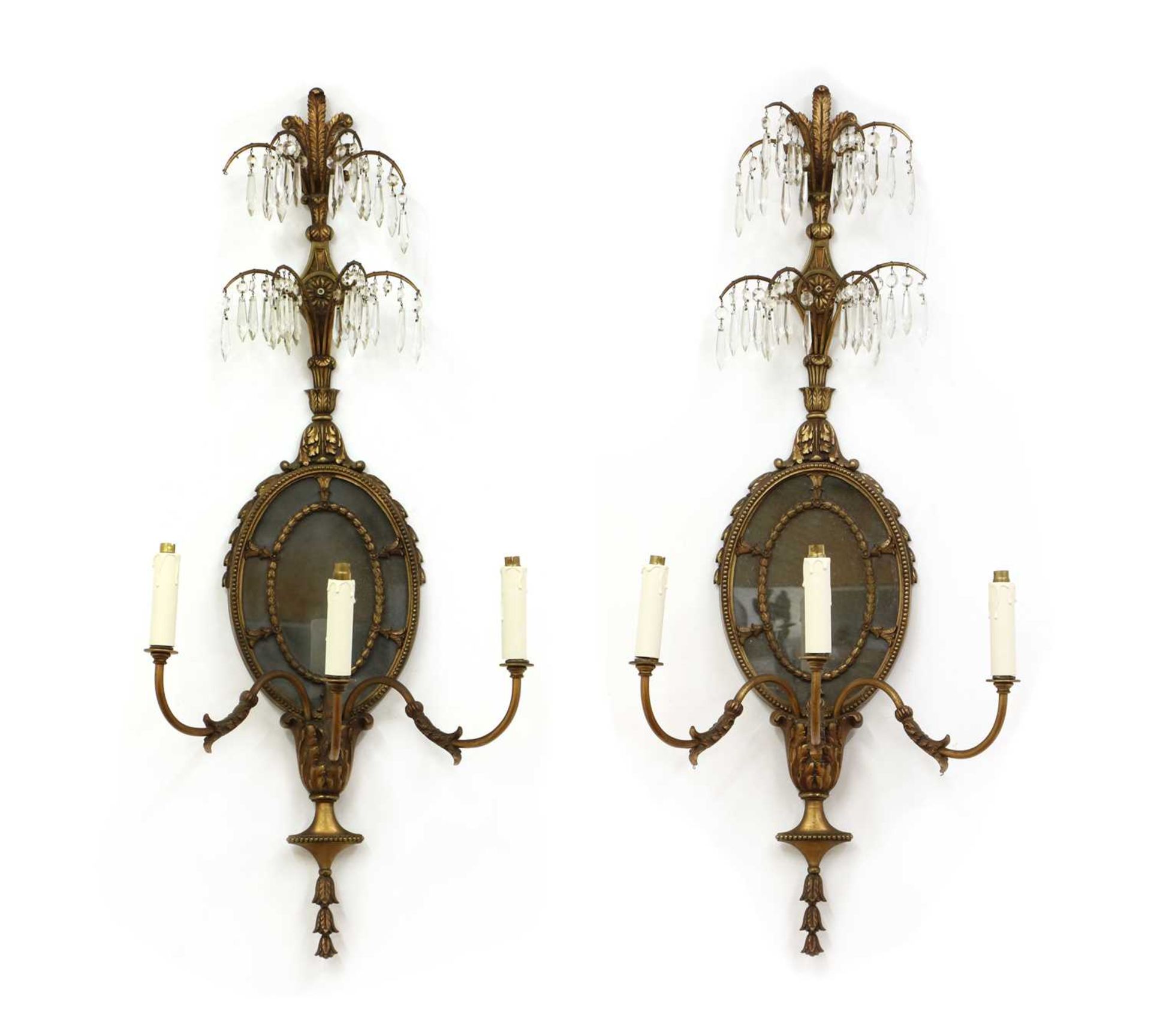 A pair of French-style neoclassical gilt metal three-branch wall lights,