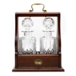 A tantalus with a pair of cut glass decanters,