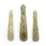 A collection of three Chinese jade belt hooks,