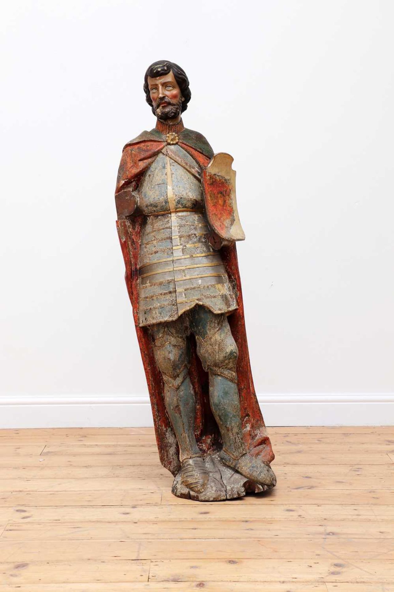 A carved and polychrome-painted figure of a knight,