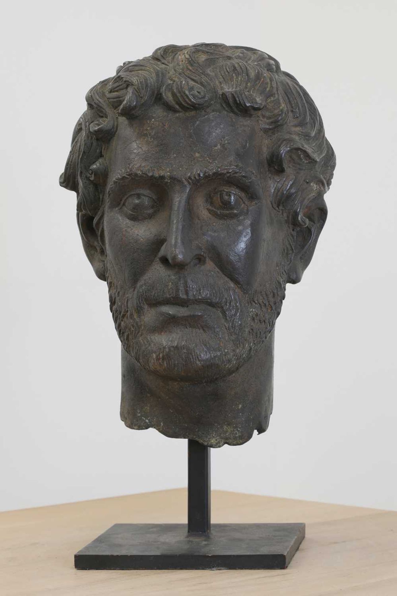 After the antique, a large bronze bust of a bearded man,