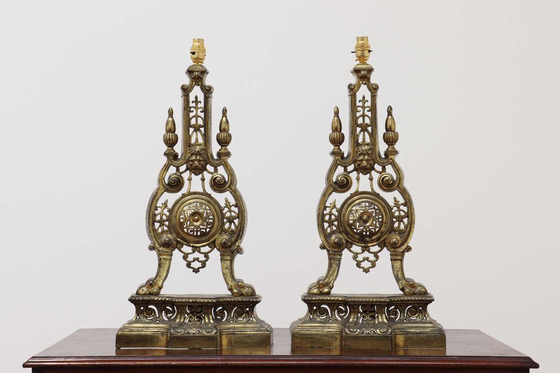 A pair of gilt-brass chenet table lamps,