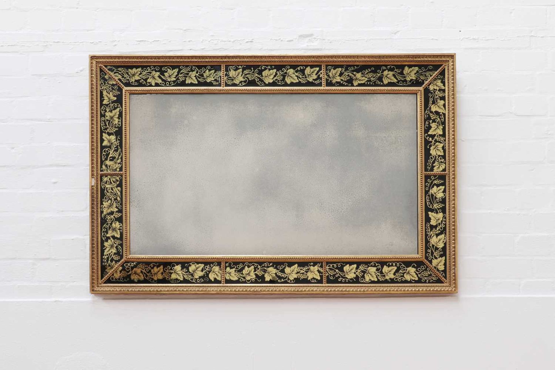 A George III-style rectangular verre églomisé mirror,