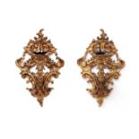 A pair of large giltwood wall appliqués,