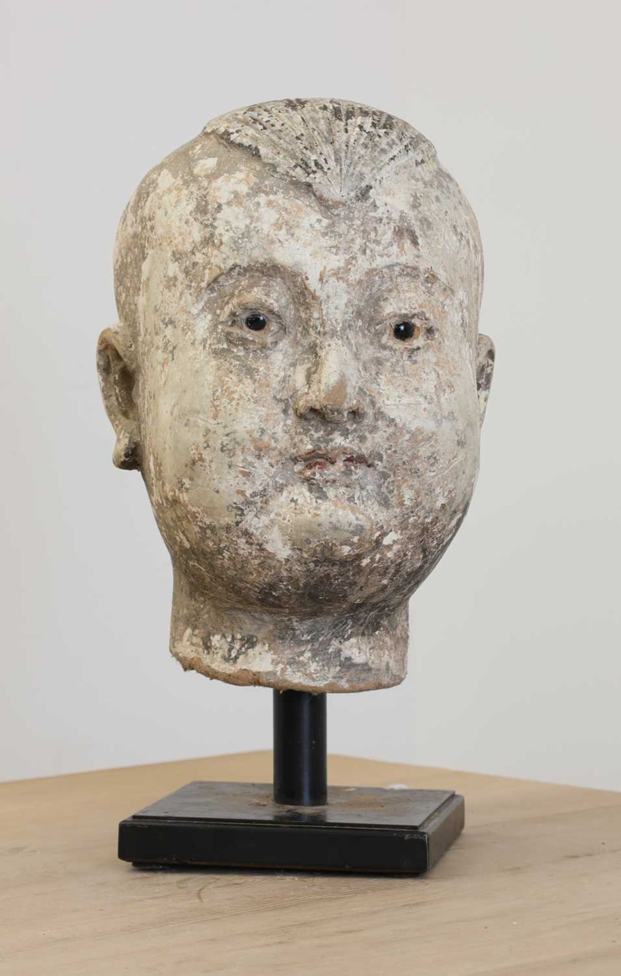 A Ming-style stucco and polychrome painted head of a child,