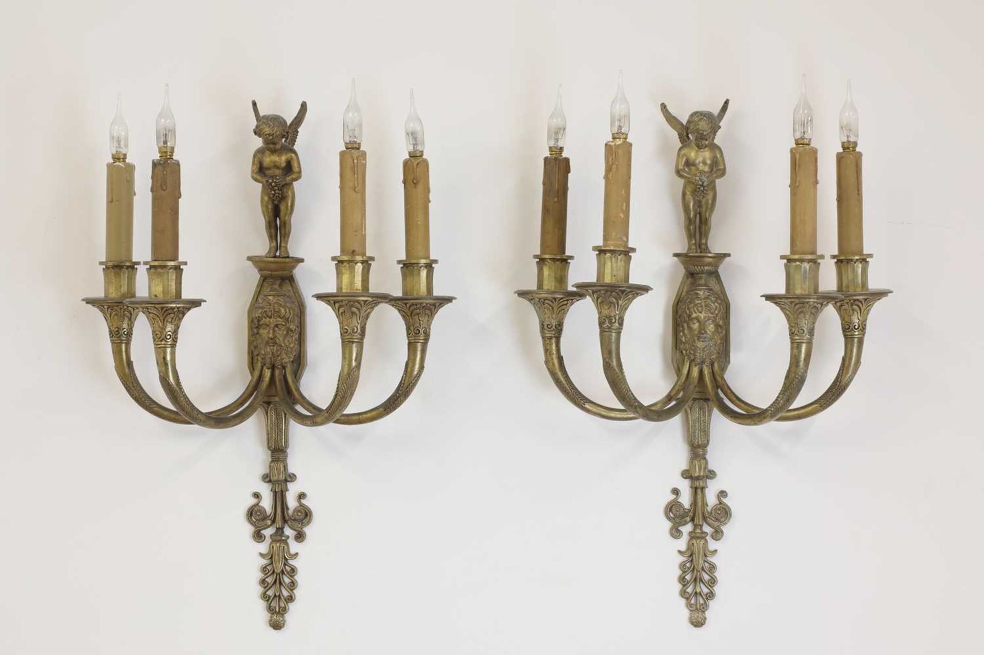 A pair of four-branch gilt-metal wall lights,