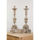 A pair of baroque carved giltwood candlestands,