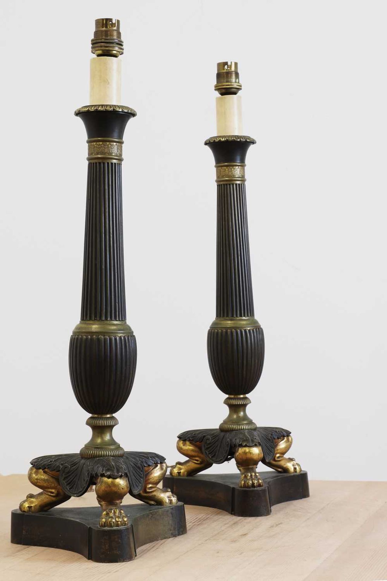 A pair of Empire-style gilt and patinated bronze table lamps,