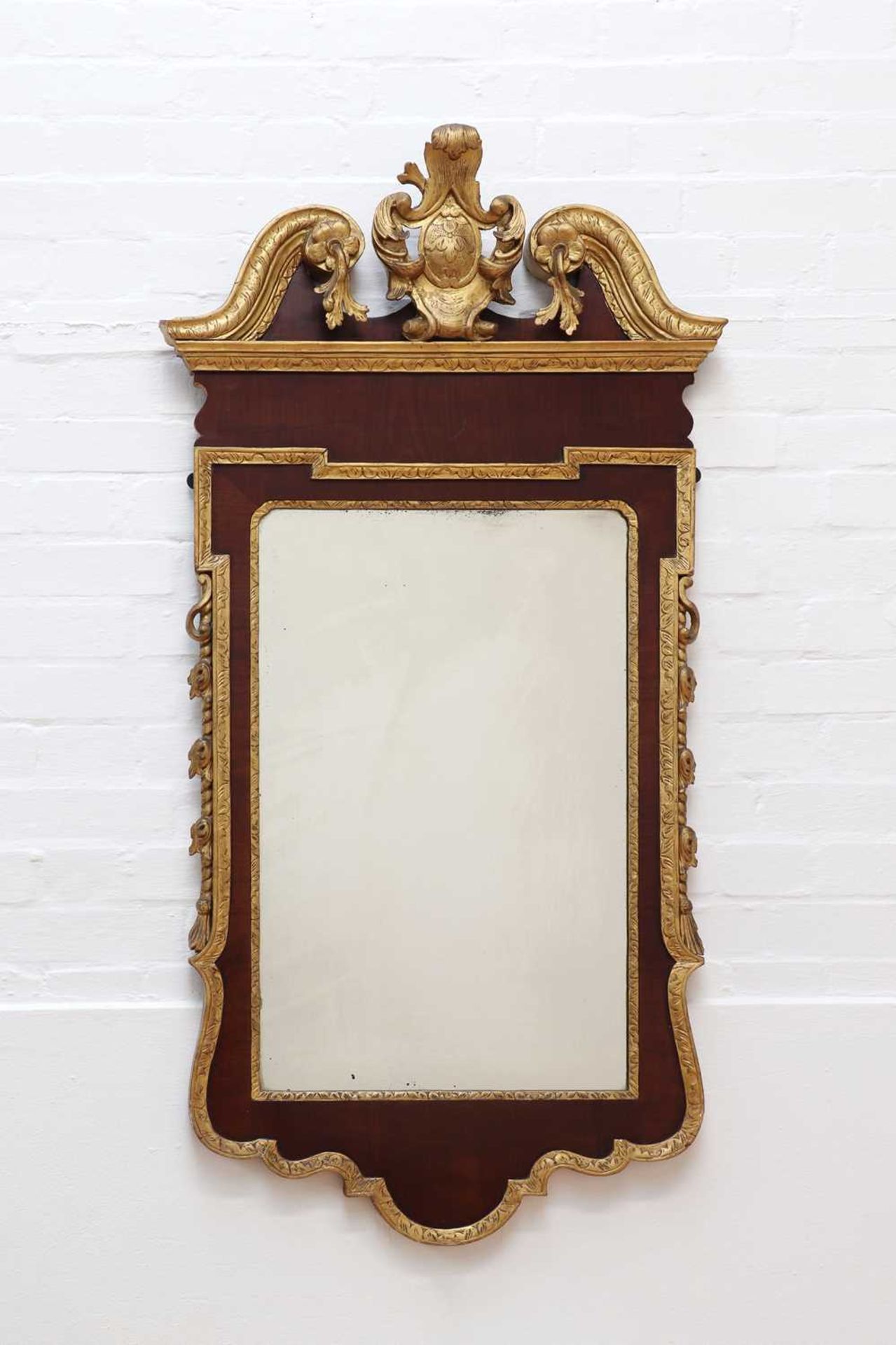 A George II-style walnut and parcel-gilt pier mirror,