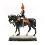 A Michael Sutty porcelain figure on horseback,