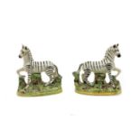 A pair of Staffordshire pottery zebras