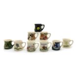 A collection of Moorcroft pottery mugs,