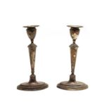 A pair of Edwardian silver candlesticks,