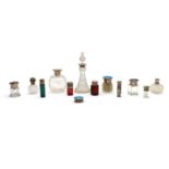 A collection of coloured and clear glass dressing table and scent bottles,