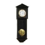 An ebonised regular wall clock,