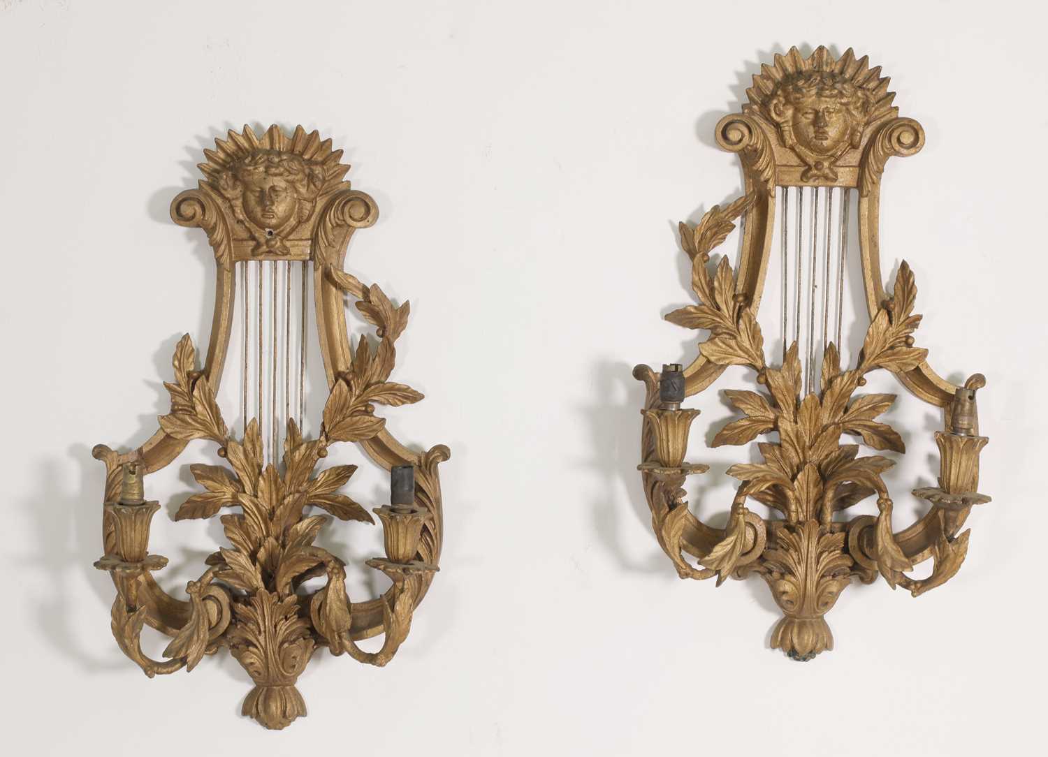 A pair of carved wooden wall lights,