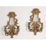 A pair of carved wooden wall lights,