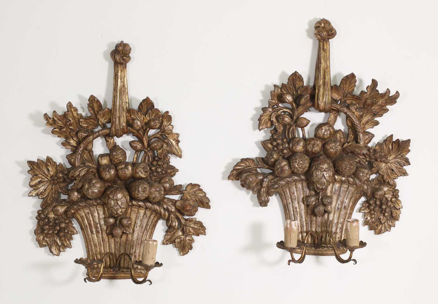 A pair of carved giltwood wall lights,