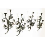A set of four green-painted wrought iron wall lights,